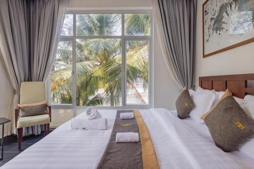 a bedroom with a bed with a large window at Pippali Boutique Hotel in Kampot