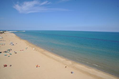 a group of people on a beach near the water at UNAHOTELS Imperial Sport Hotel in Pesaro