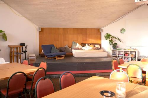 a room with a couch and tables and chairs at Gästehaus Maria Rast in Suderburg