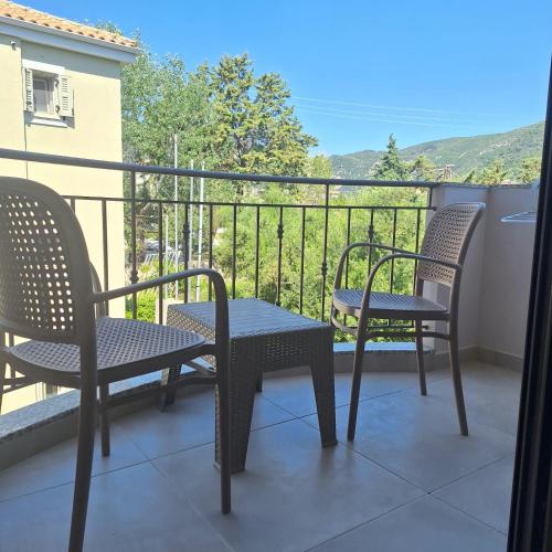 two chairs and a table on a balcony at Kipos Suites Nidri Lefkada in Nydri