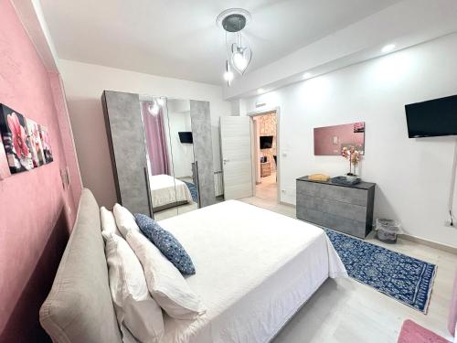 a bedroom with a large bed and a tv at Stefy's House in Scalea