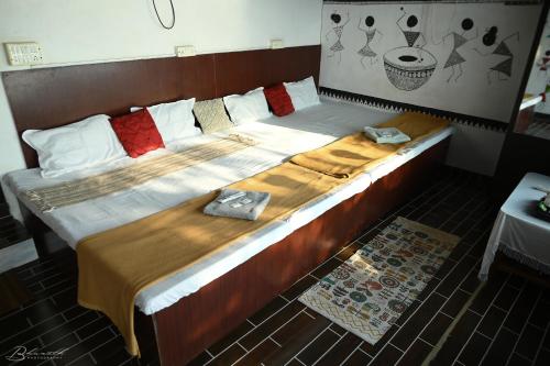 a large bed in a room with towels on it at Sattva camps and cottages - Udupi in Udupi