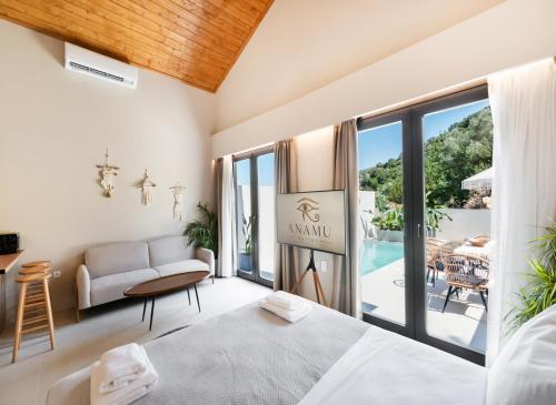 a bedroom with a bed and a living room at Anamu Suites in Kondáraina