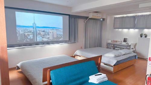 a hotel room with two beds and a large window at Youki Residence in Tokyo