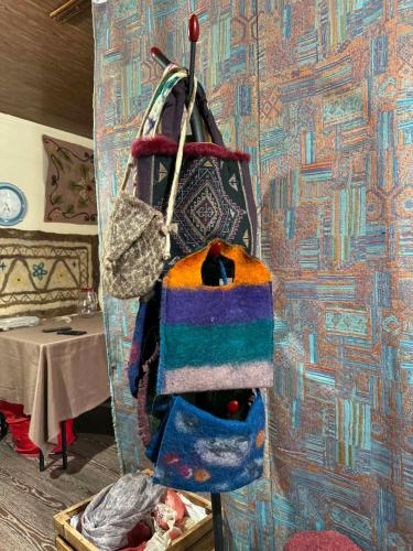 a bunch of bags hanging on a wall at Art Vila Galeri in Kazbegi