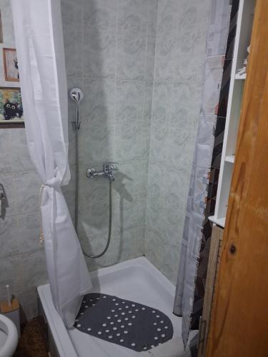 a bathroom with a shower with a shower curtain at Sunshine- self sheck in in Čačak