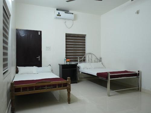 a room with two beds in a room at Athirappilly Ambady Resort in Athirappilly