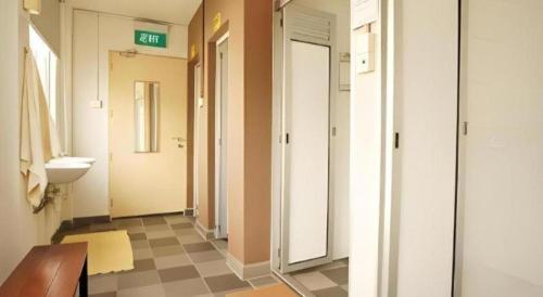 a bathroom with a hallway with a sink and a toilet at G4 Station Backpackers Hostel in Singapore