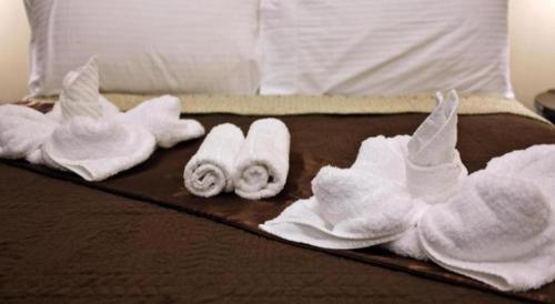 a group of towels on top of a bed at Peridot Suites in Buhangin