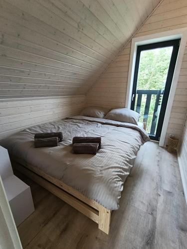a bedroom with a bed with two bags on it at Stodoła na Kaszubach in Gowidlino