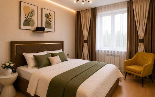 a bedroom with a bed and a chair and a window at Elim-Ai in Kokshetau