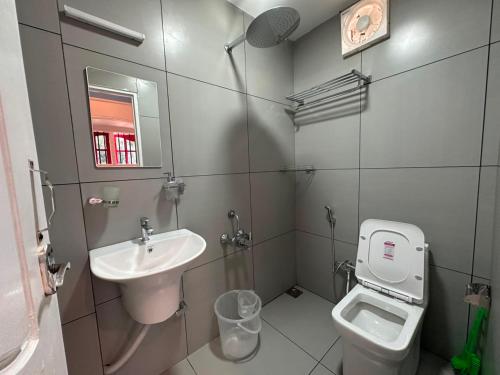 a small bathroom with a sink and a toilet at Hope Hostels, Fort Kochi in Fort Kochi