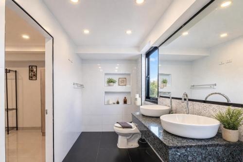 a bathroom with two sinks and a toilet at Luxury Pool Villa Pattaya Center C8 - 4 Bedroom in Pattaya South