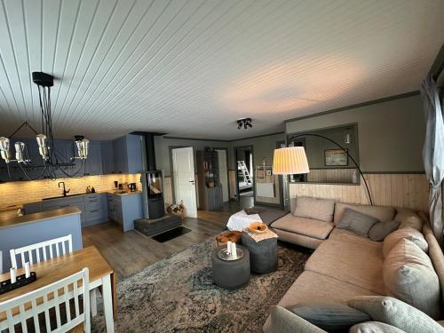 a living room with a couch and a kitchen at Fishermans luck in Arvidsjaur