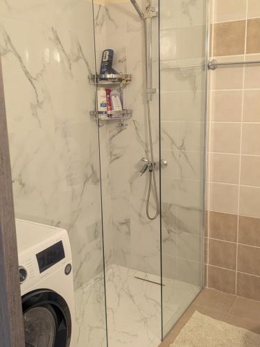 a shower in a bathroom with a washing machine at Kiti 2 bedroom Penthouse in Kiti