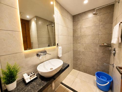 a bathroom with a sink and a mirror at HOTEL in PURI - SWIMMING POOL RB - Near Sea Beach & Shree Jagannath Temple - wifi - Parking - Restaurant - in Puri