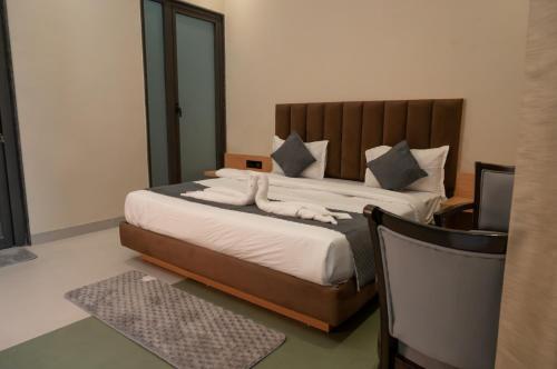 a bedroom with a large bed and a television at Sukuun Villa Airport Road #Luxury Pool Stay in Sri Guru Ram Dass Jee International Airport