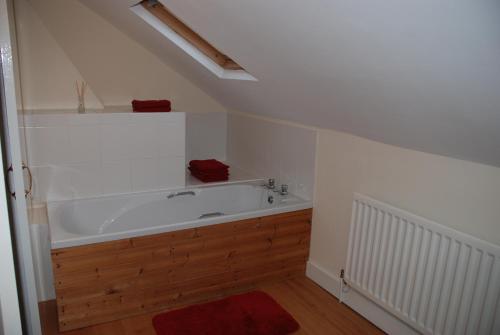 a bathroom with a large bath tub in a attic at Apartment Bijou in Durham