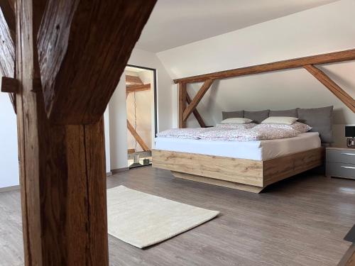 a bedroom with a bed and a mirror at Ferienwohnung Sabrina in Aichen