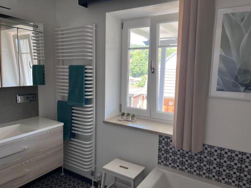 a white bathroom with a window and a sink at Ferienwohnung Sabrina in Aichen