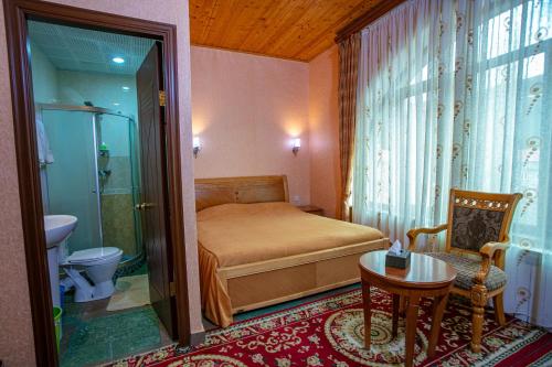 a small bedroom with a bed and a bathroom at Nairi Hotel in Jermuk