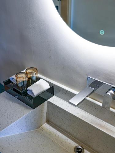 a bathroom sink with two candles on a tray at Aomori Hotel -Foshan Shunde Qinghui Garden Resort OCT Harbour PLUS Branch in Shunde