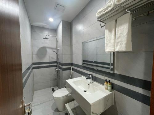 a white bathroom with a sink and a toilet at Mori Khem Beach Homestay in Phú Quốc