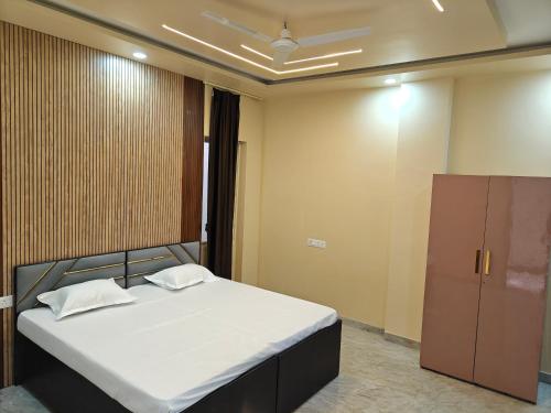 a bedroom with a bed and a cabinet at Diksha Heritage In in Prayagraj
