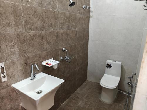 a bathroom with a sink and a toilet at Diksha Heritage In in Prayagraj