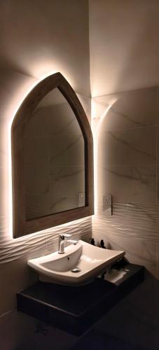 a bathroom with a sink and a mirror at Coco Villa in Talpe