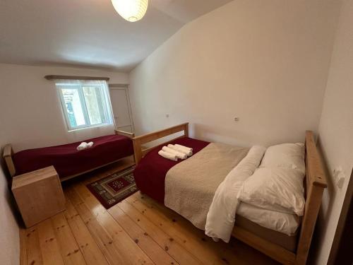 a small bedroom with a bed and a window at Guesthouse Gama in Khevsureti in Roshka