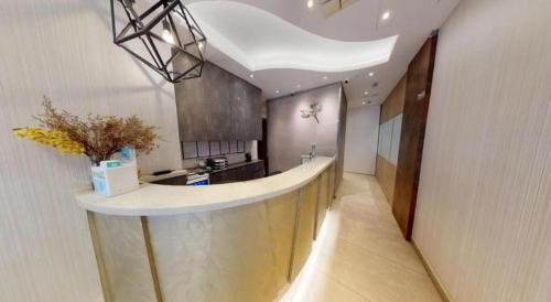 a large kitchen with a counter in a room at Metroplace Olympic in Hong Kong