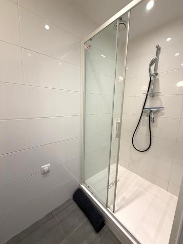 a shower with a glass door in a bathroom at Palace Riviera Studio - Plages & Centre Menton in Menton