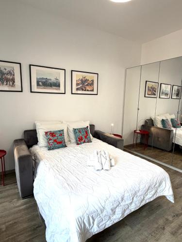 a bedroom with a large white bed with pillows at Palace Riviera Studio - Plages & Centre Menton in Menton