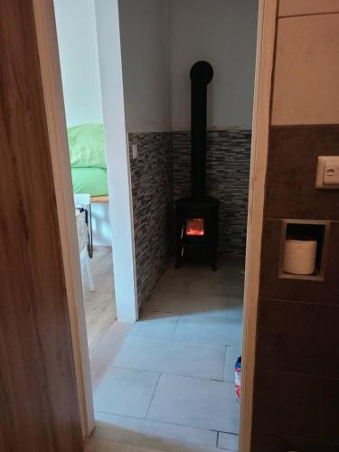 a room with a wood stove in a room at Aichinger in Hanušovice