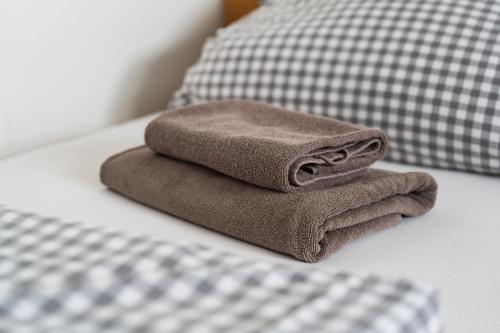 a pile of towels sitting on top of a bed at Fewo 14 DG in Goch