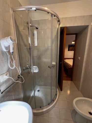 a shower with a glass door in a bathroom at Albergo Brustolon in Dont