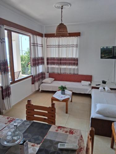 a living room with a couch and a table at Porto Beach Apartment in Makry Gialos