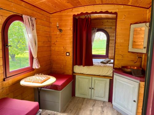 a cabin with a sink and a table in it at La Bohème aux wallabies in Pajay