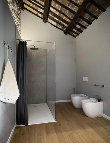 a bathroom with a glass shower and a toilet at Il Palazzetto - La terrazza di Elia in Cividale del Friuli