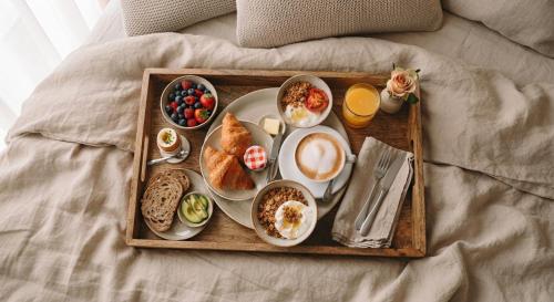 a tray of breakfast foods on a bed at Grand Liman Hotel in Baku