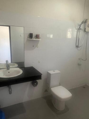 a bathroom with a white toilet and a sink at theorenda 002 in Koh Samui