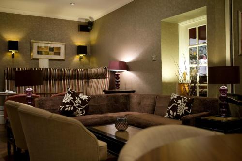 a living room with a couch and a table at Ardington Hotel in Worthing