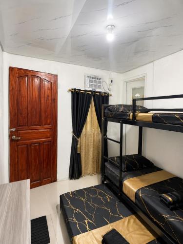 a room with two bunk beds and a door at D Haven Space Rental in La Carlota