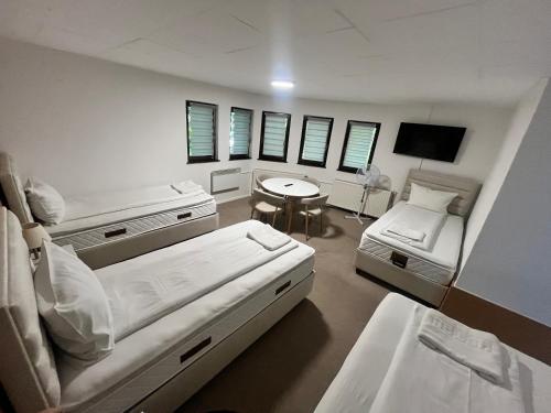 a hospital room with two beds and a table at Guest House LIKE in Sarajevo