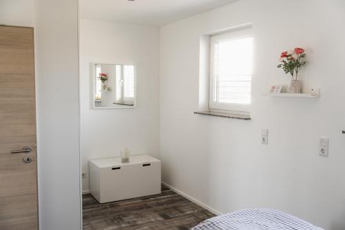 a white room with a bed and a window at Lebensfreude in Goch