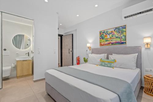 a bedroom with a large bed and a bathroom at Athens Theatrou Apartments in Athens