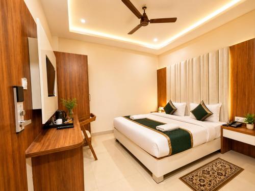 a hotel room with a bed and a desk at HOTEL NEAR KASHI VISHWANATH VARANASI SHREE R-KRISHNA - wifi - Lift - FAMILY HOTEL in Varanasi