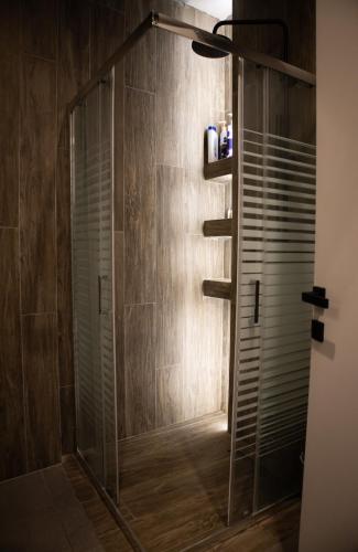 a shower with a glass door in a bathroom at Kalma Apartment Xanthi Center in Xanthi