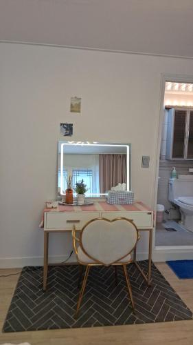 a desk with a mirror and a chair in a room at Daol in Seoul